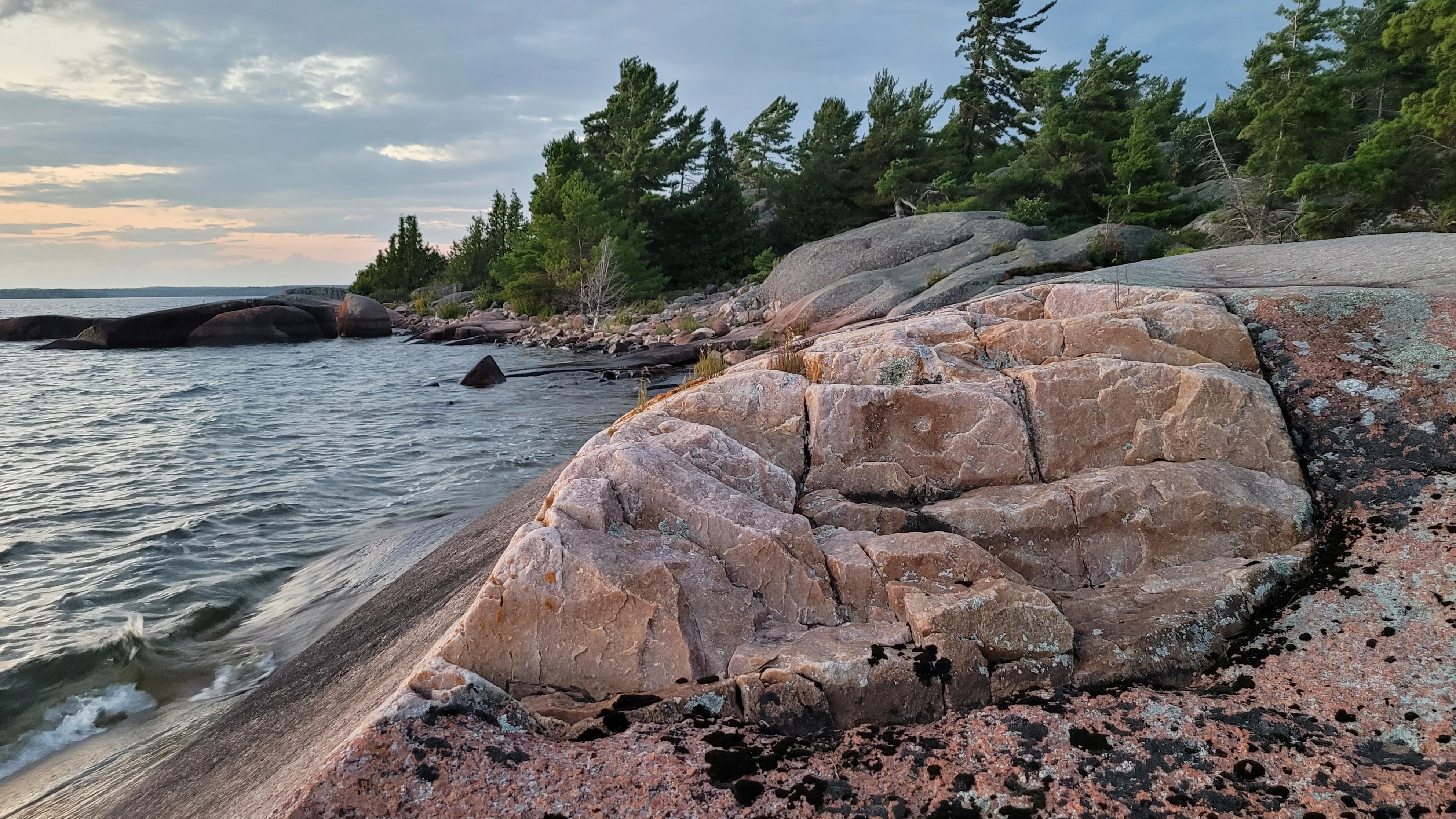 A striking white quartzite cliff blanketed with crystal clear waters on the Benjamin Islands in Northern Ontrario, Canada