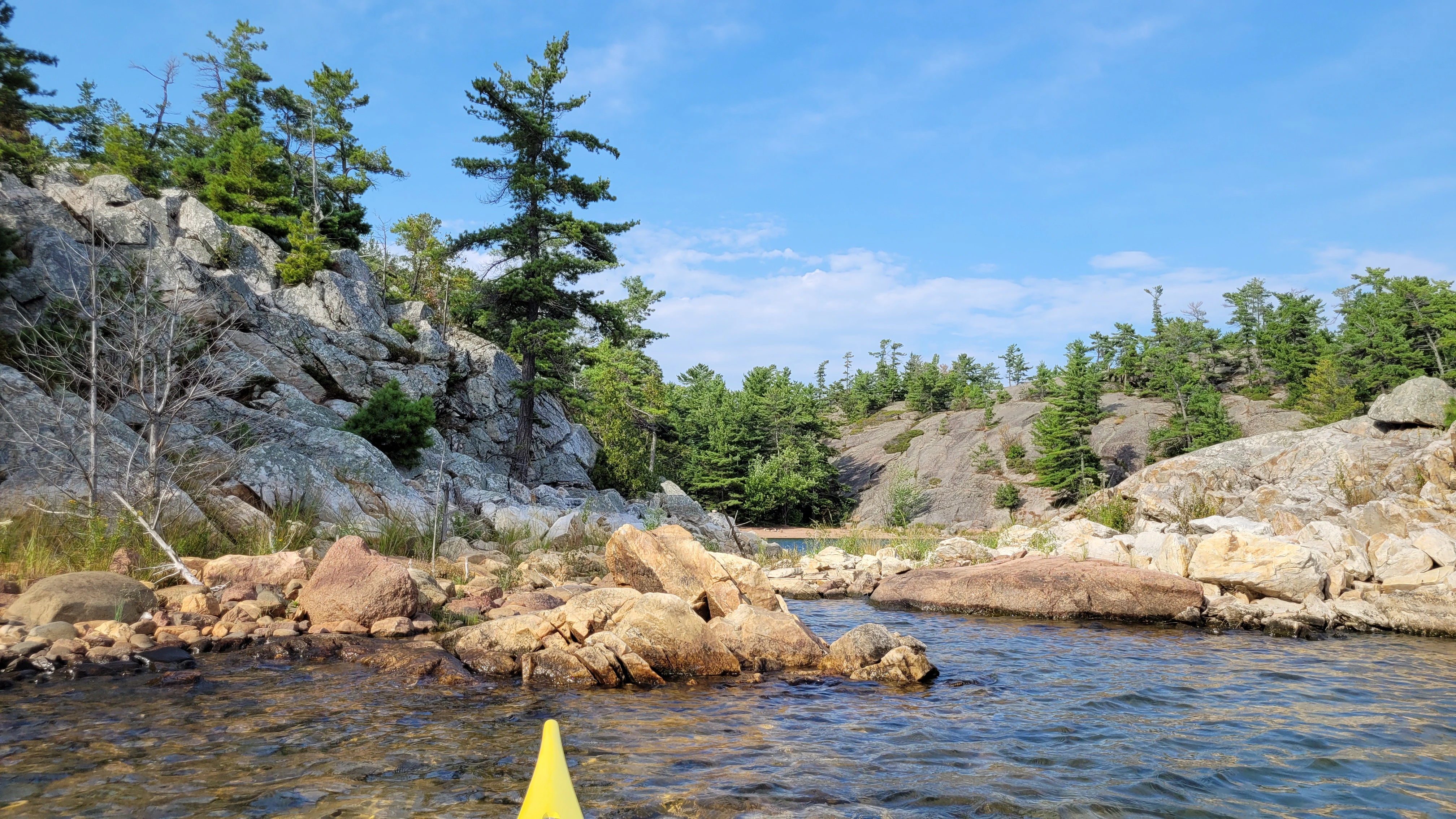 Smooth red granite cliffs meet white quartzite cliffs on the Benjamin Islands in Northern Ontrario, Canada