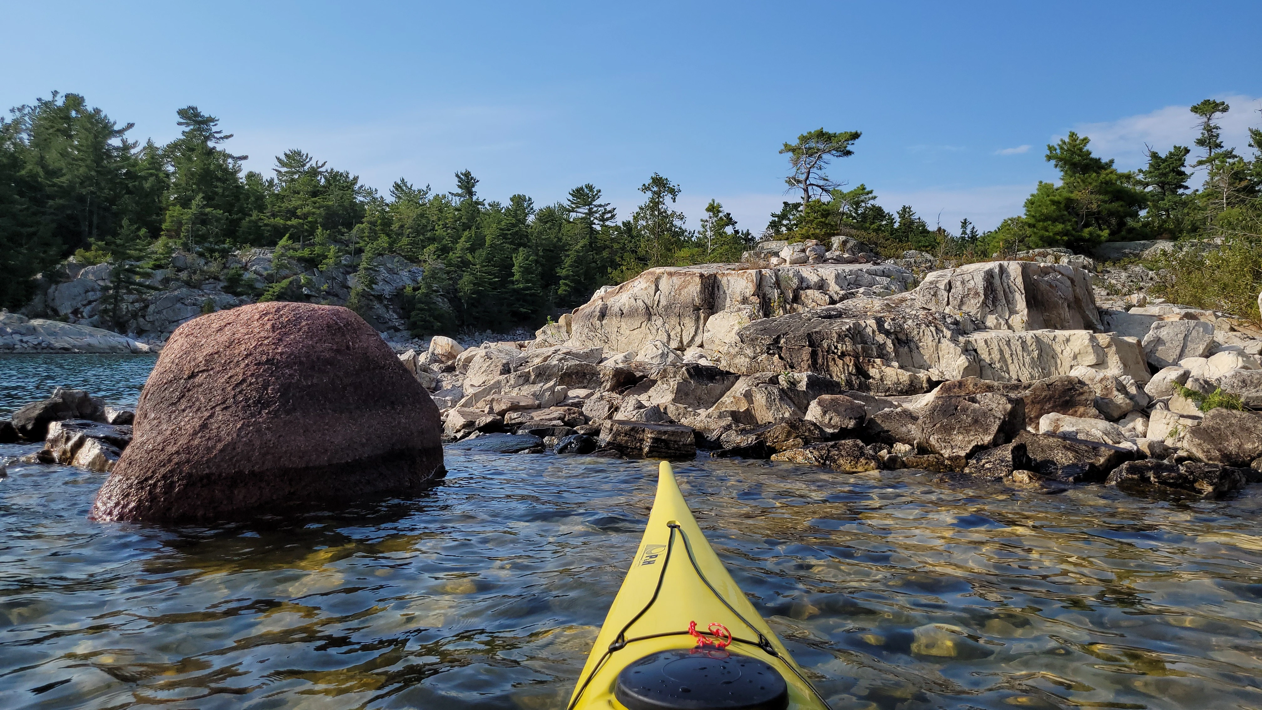 Kayaking past Red Granite and White Quartzite at Benjamin Islands in Northern Ontrario, Canada