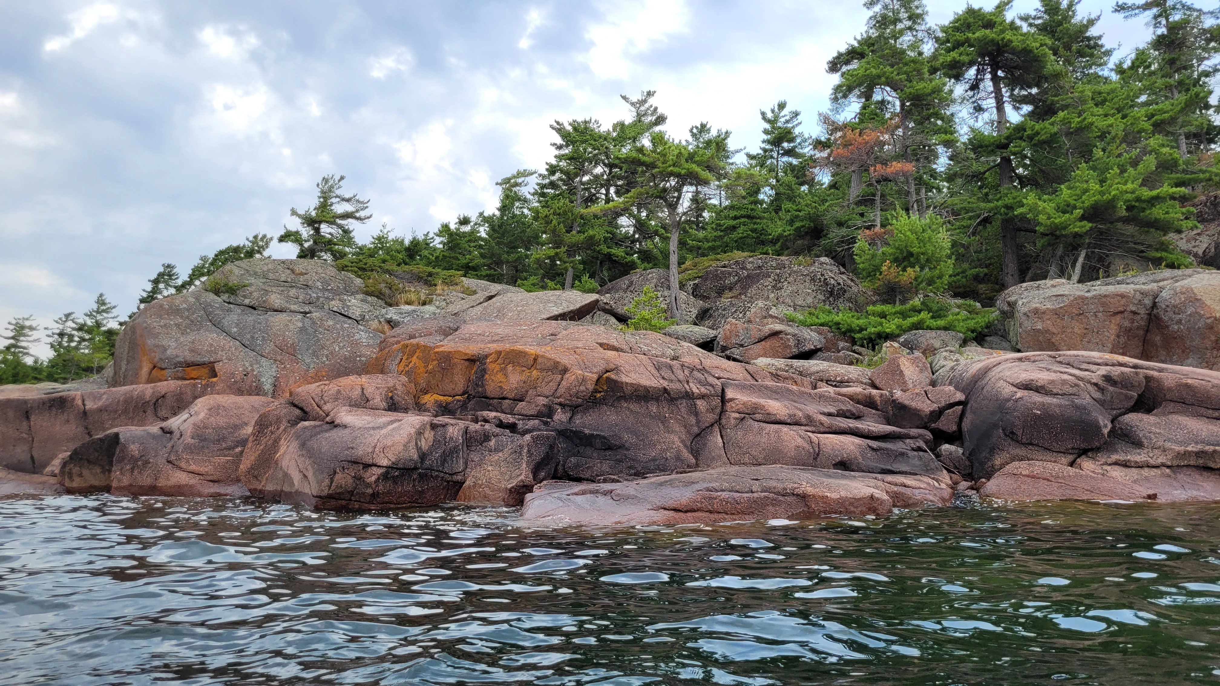 Red granite rocks and pine trees on the Benjamin Islands in Northern Ontrario, Canada
