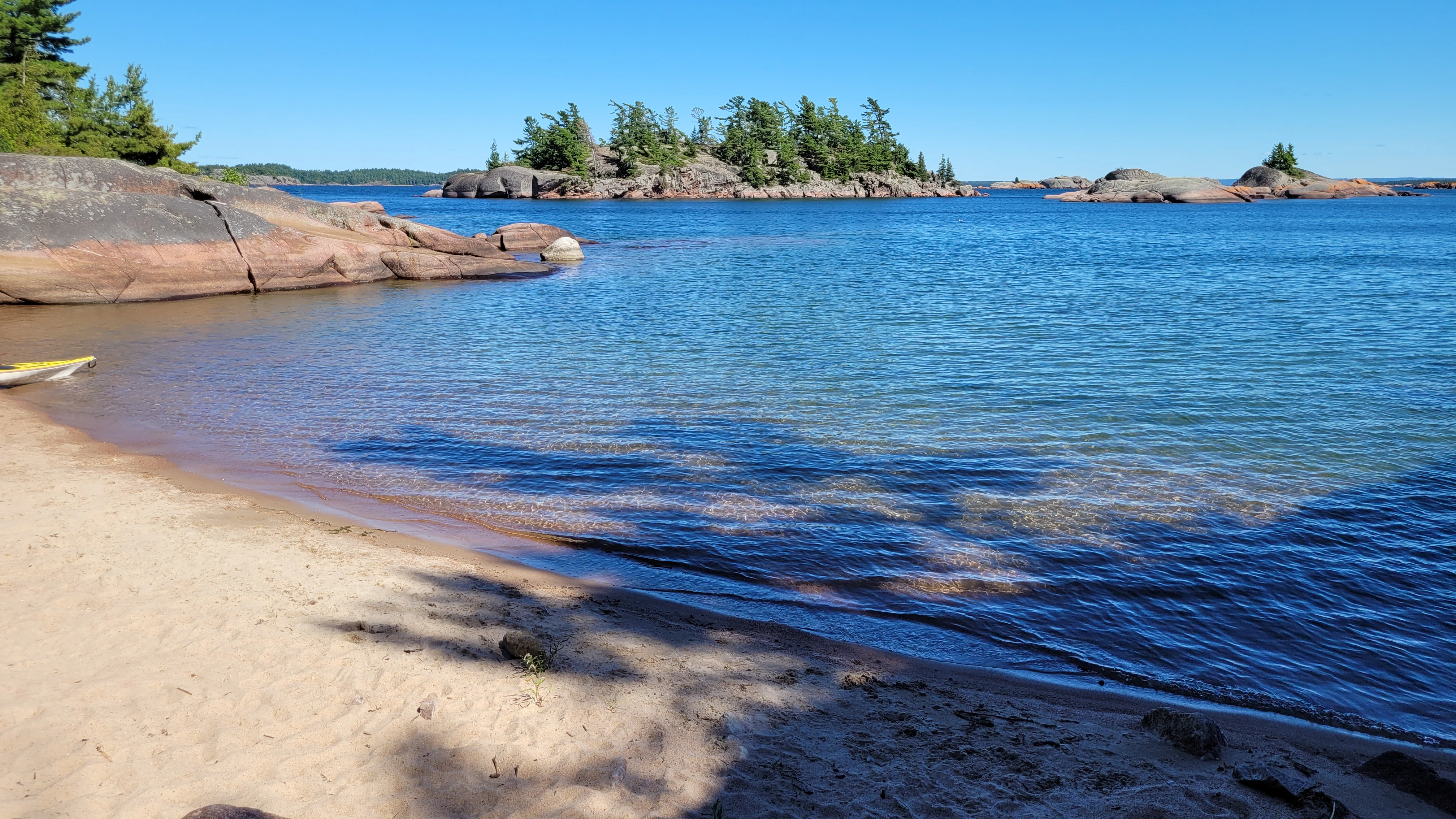A sandy beach surrounded by islands on South Benjamin Island in Northern Ontrario, Canada