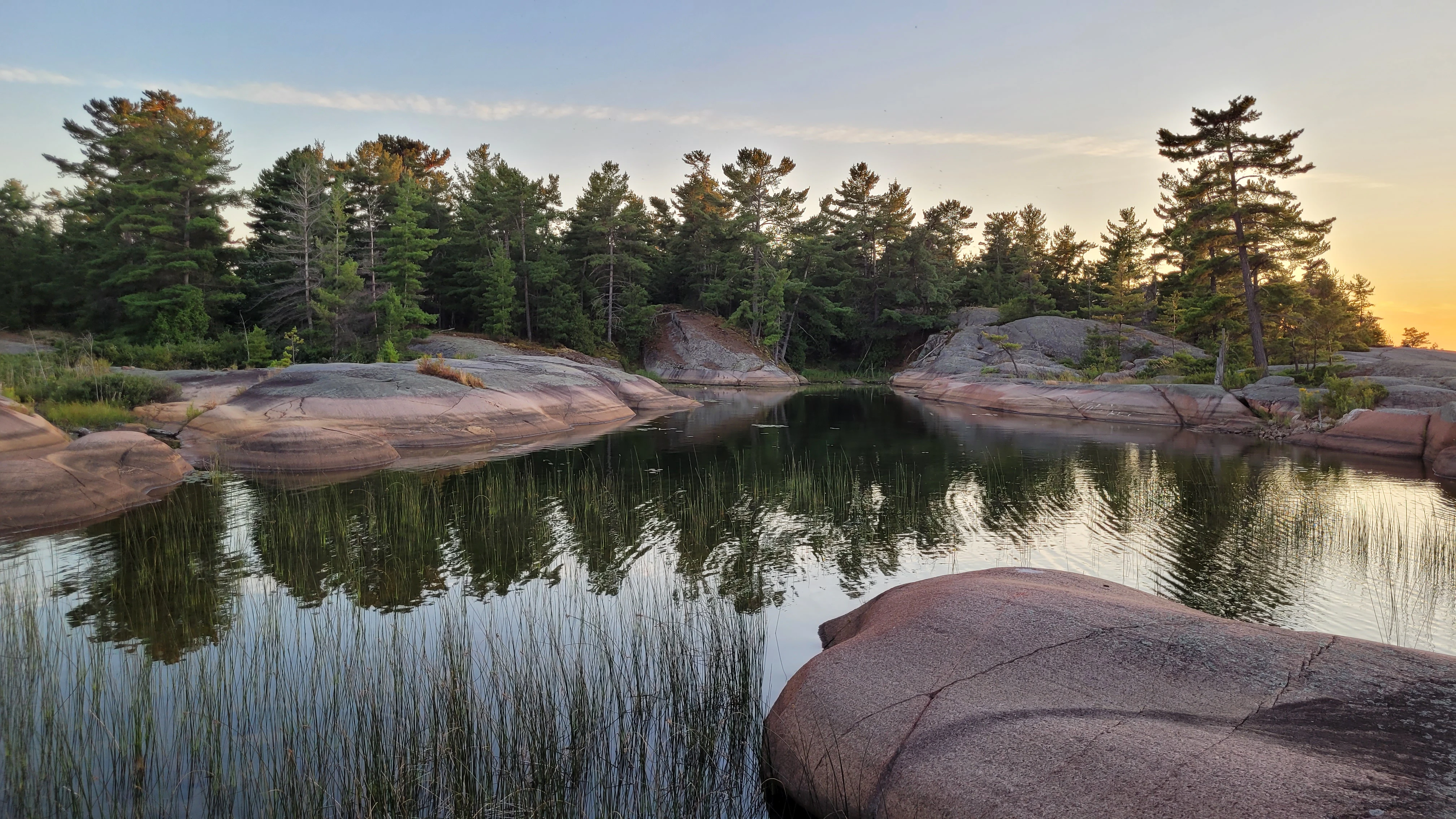Sunset over smooth granite rocks on the Benjamin Islands in Northern Ontrario, Canada
