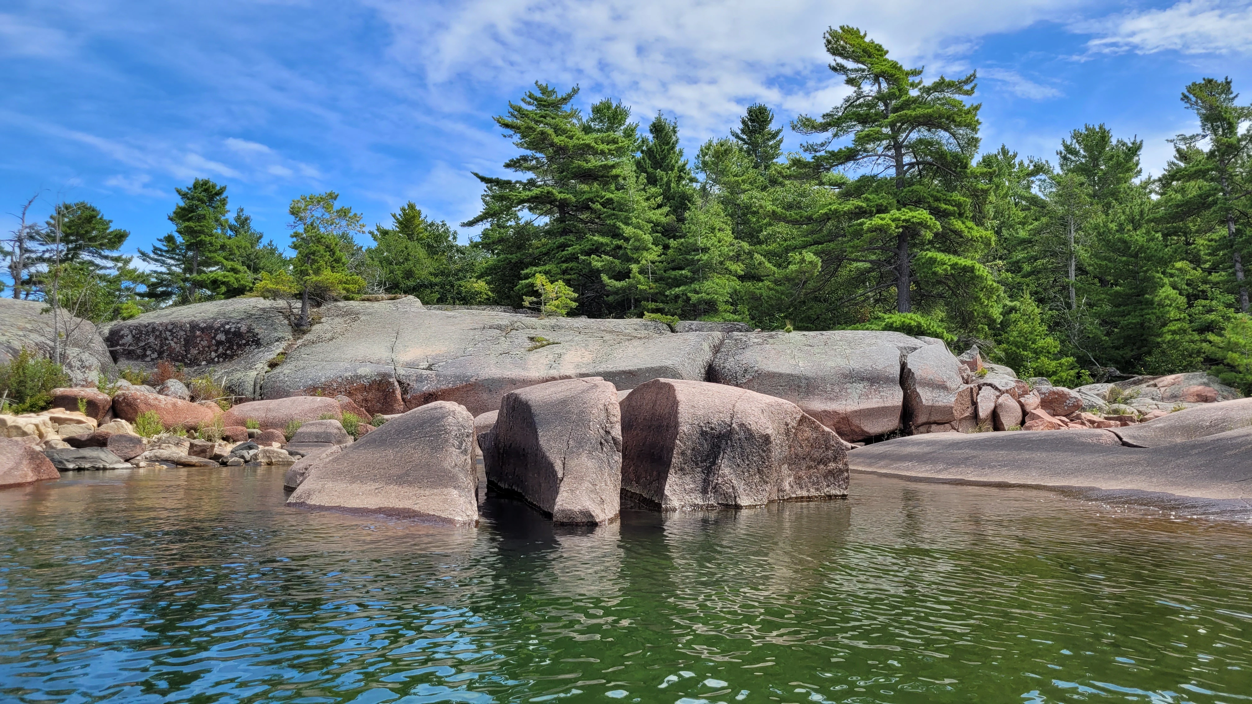 Red granite rocks along the shore of South Benjamin Island in Northern Ontrario, Canada