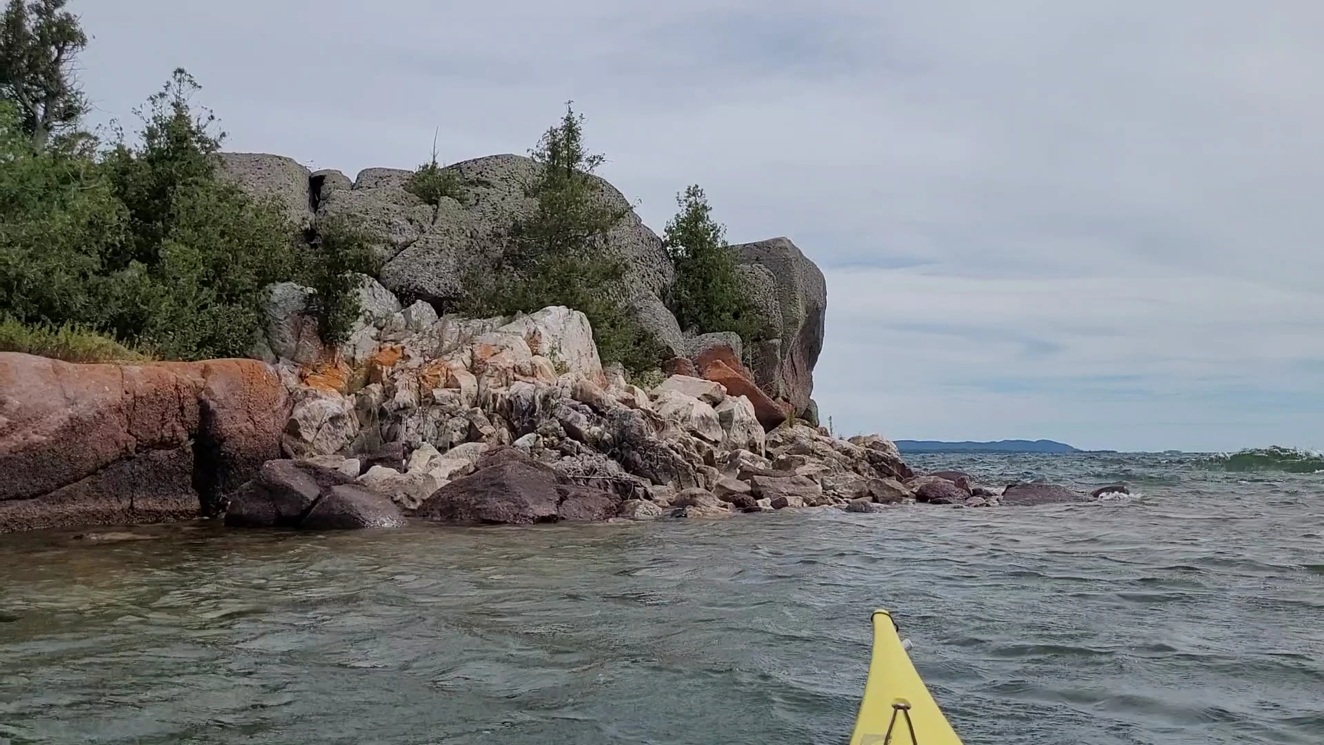 Kayaking past an Island with granite and quartzite near the Benjamin Islands in Northern Ontrario, Canada