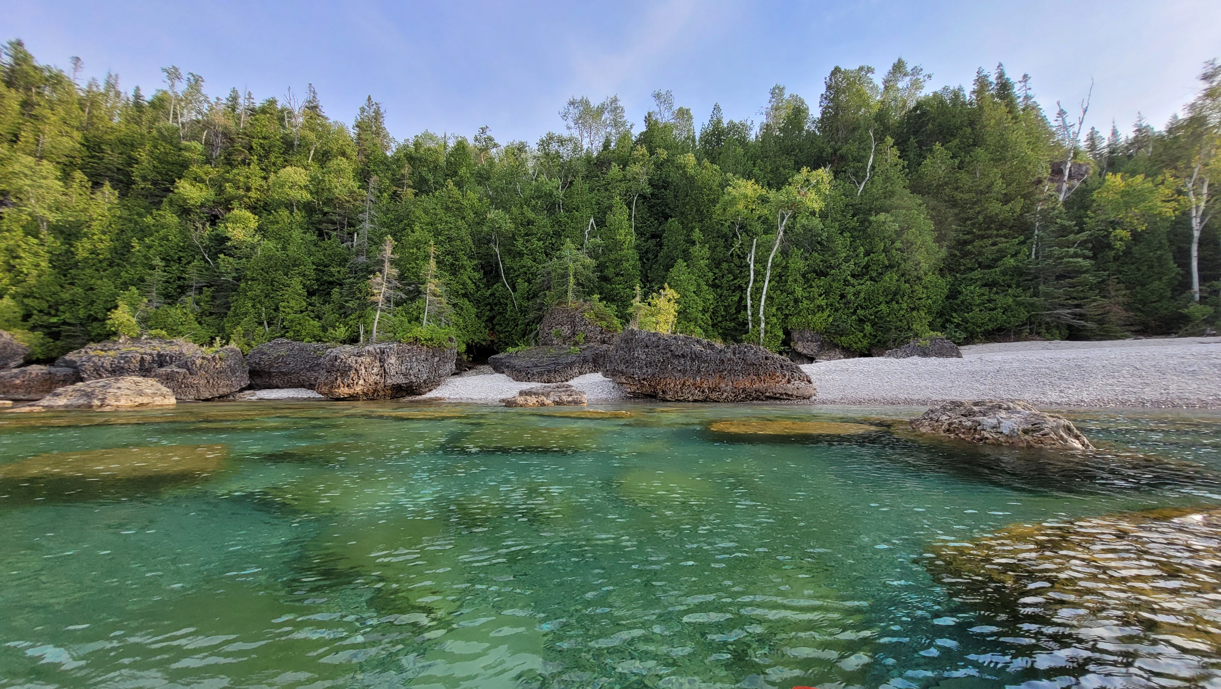 Cobblestone beach and large boulders deep inside Driftwood Cove
