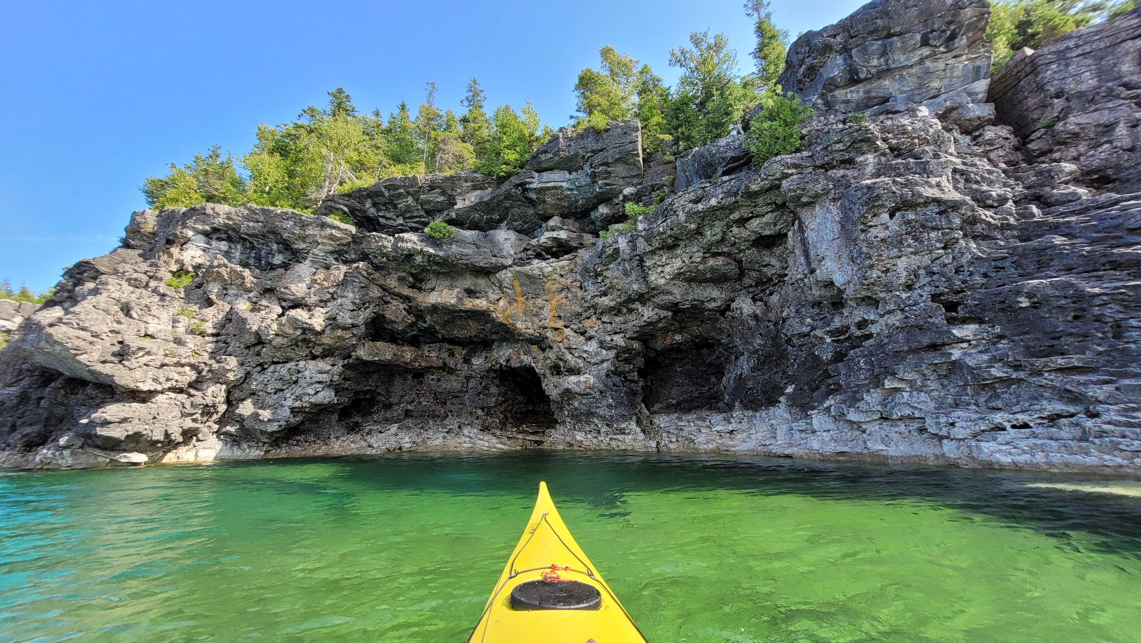 Cave-like rock formations carved into the Bruce Peninsula shoreline