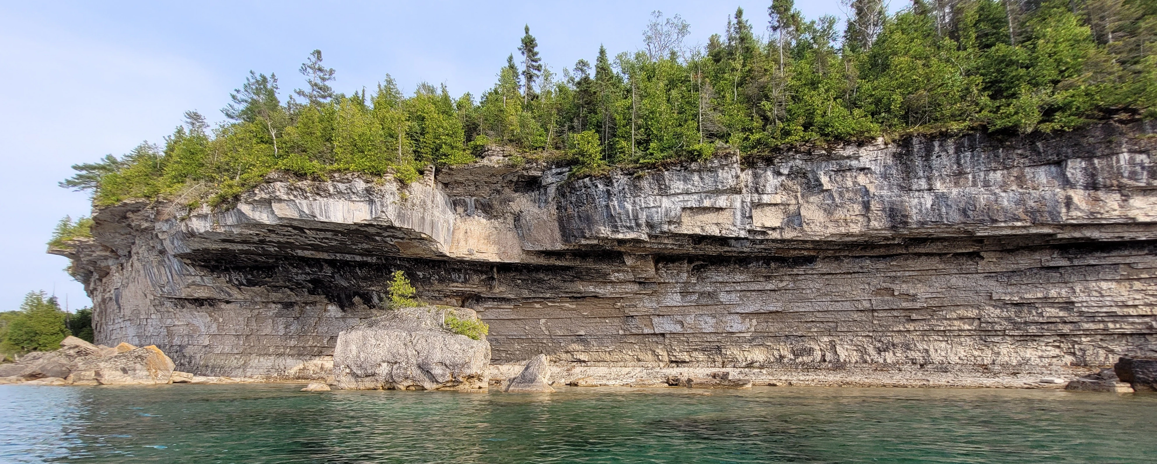 Towering limestone cliff crowned with cedar trees on the Bruce Peninsula