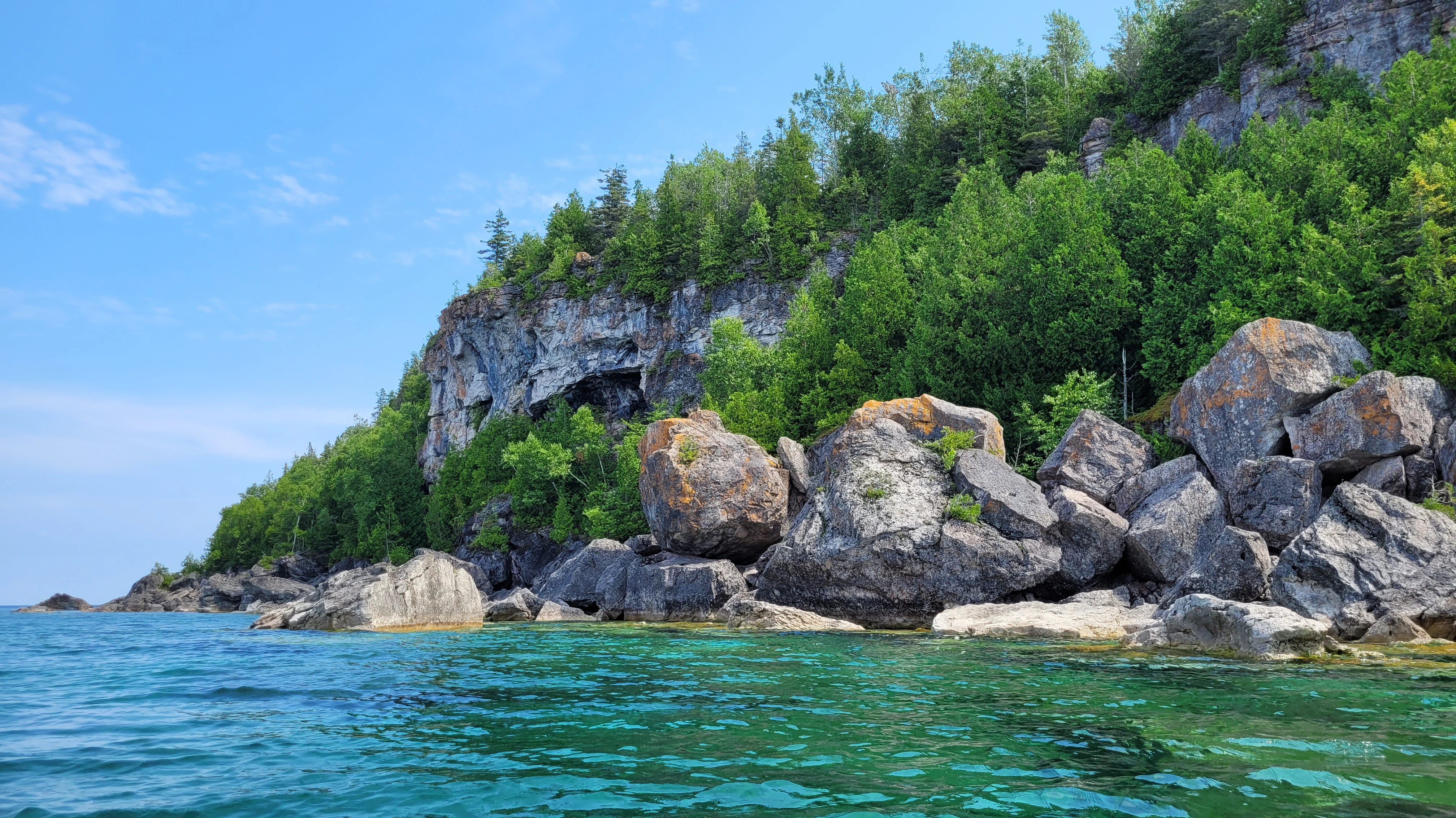 Massive limestone cliffs and boulders along the Bruce Peninsula shoreline
