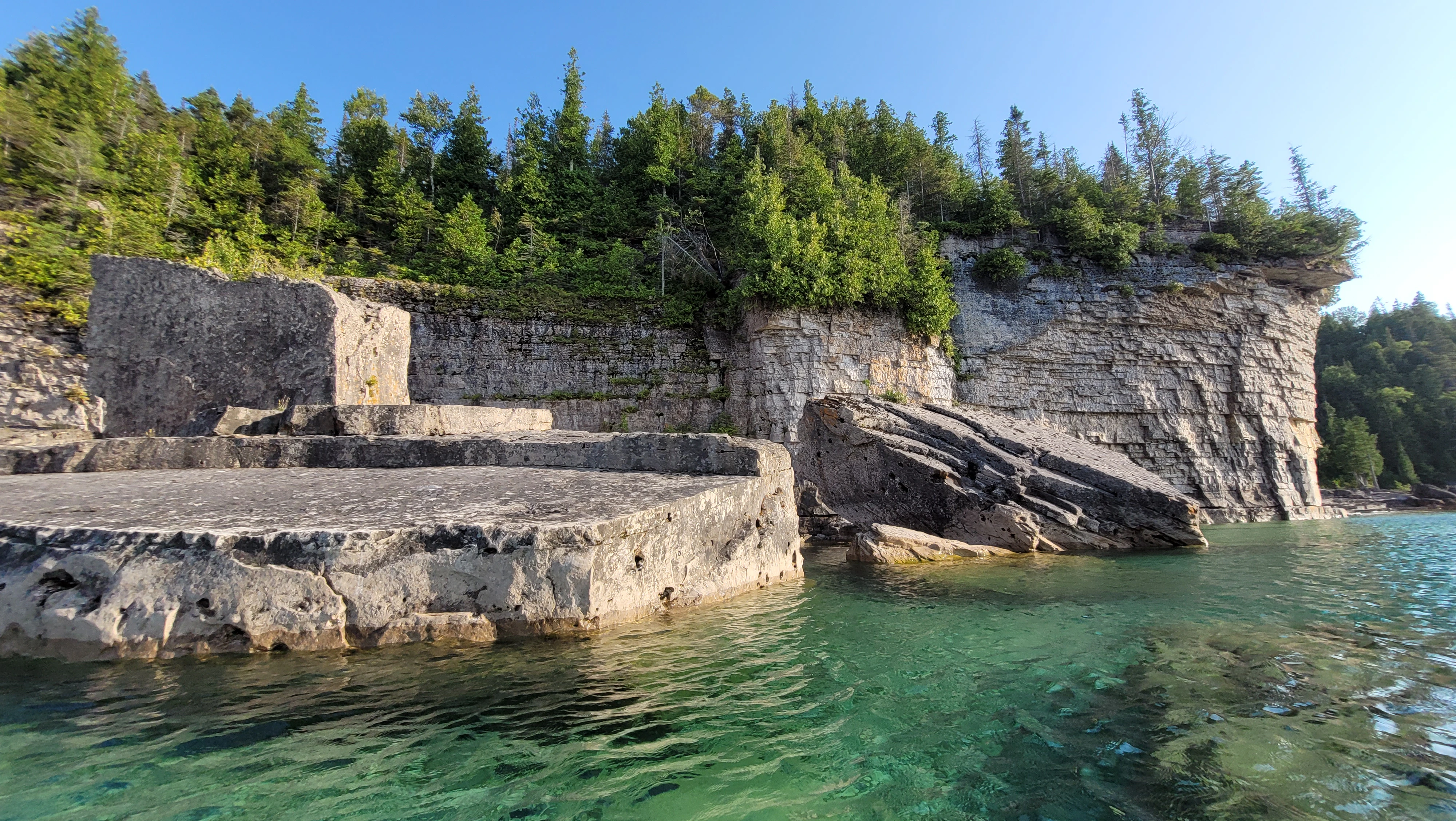Limestone cliffs and fallen boulders in Driftwood Cove