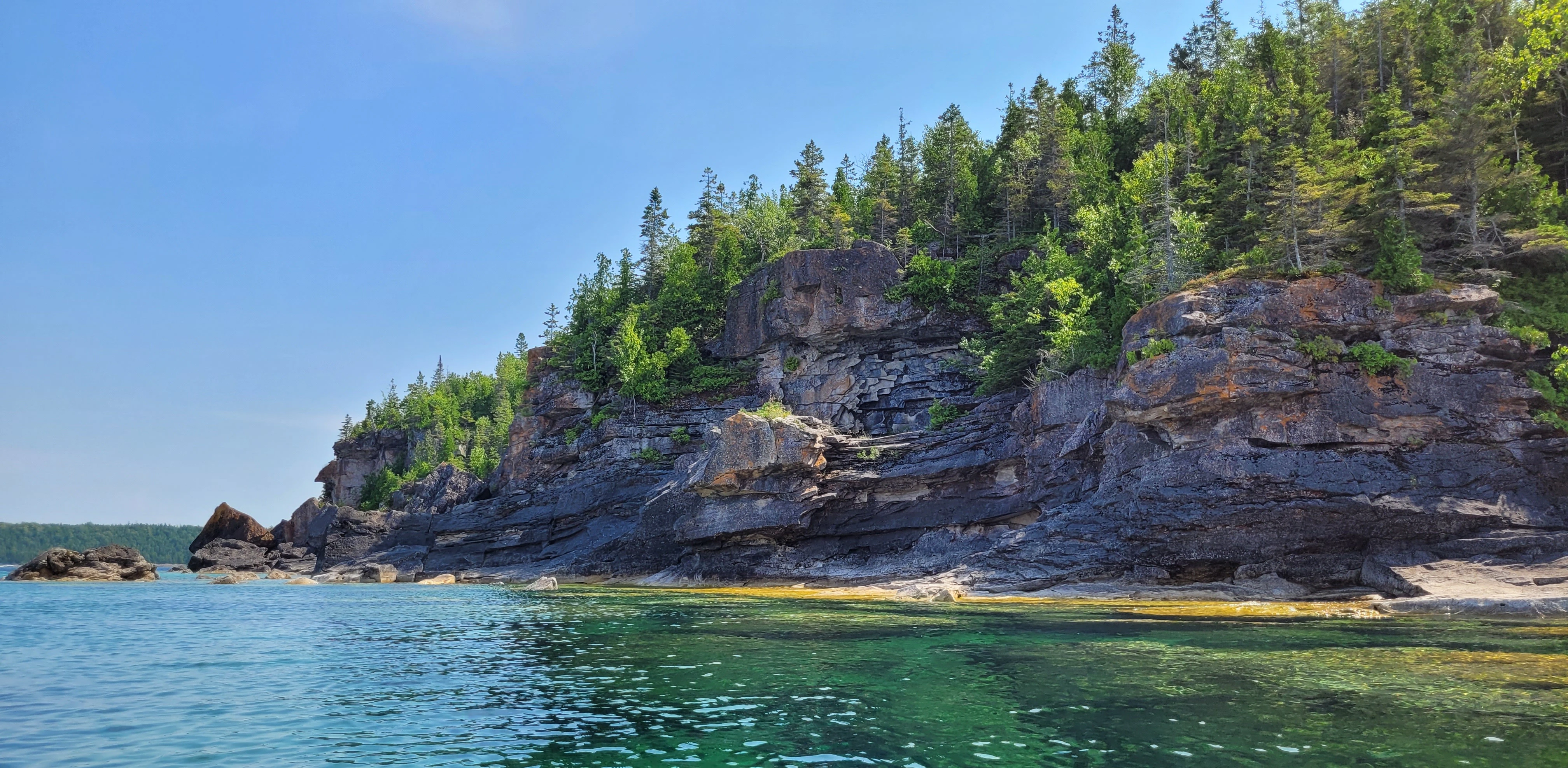 White cliffs along the shoreline before reaching Driftwood Cove