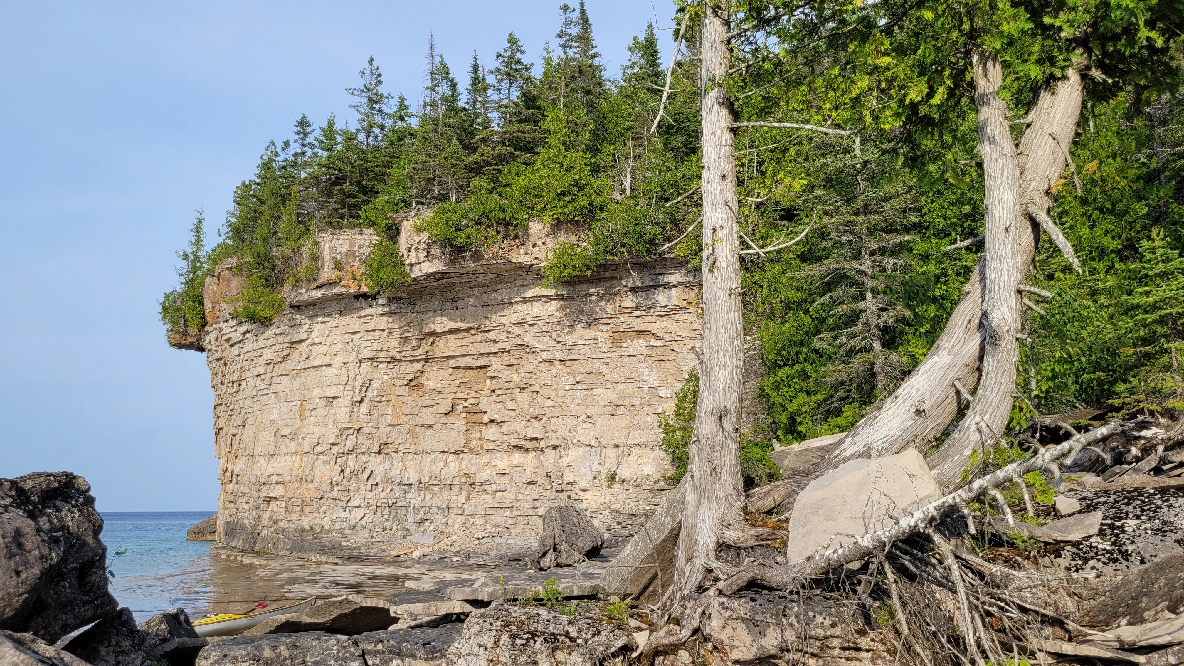Sea kayak resting beside castle-like cliffs in Driftwood Cove