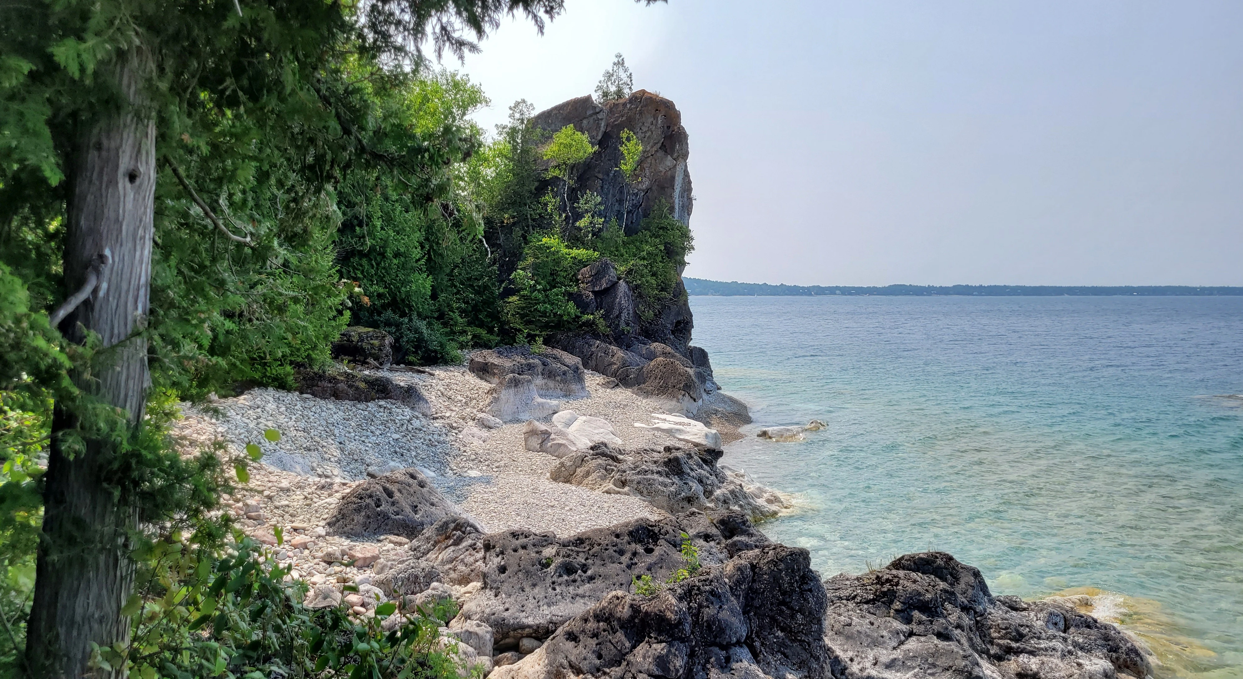 Sea kayak approaching the limestone cliffs of Lions Head on the Bruce Peninsula in Ontario Canada