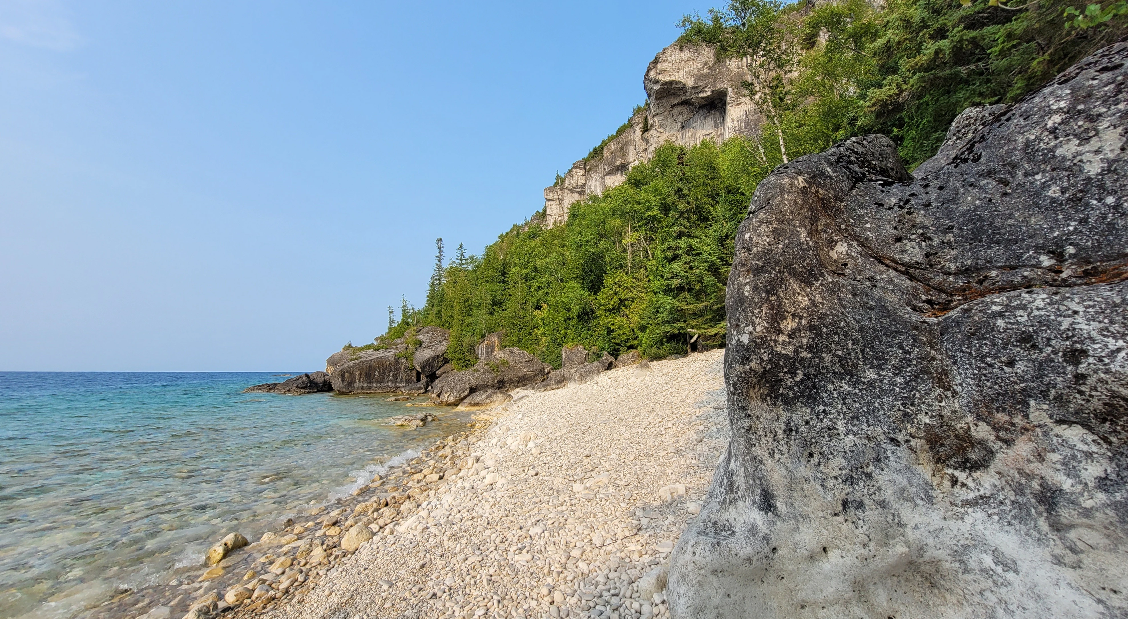 Kayaking beneath dramatic cliffs at Lions Head Ontario Canada