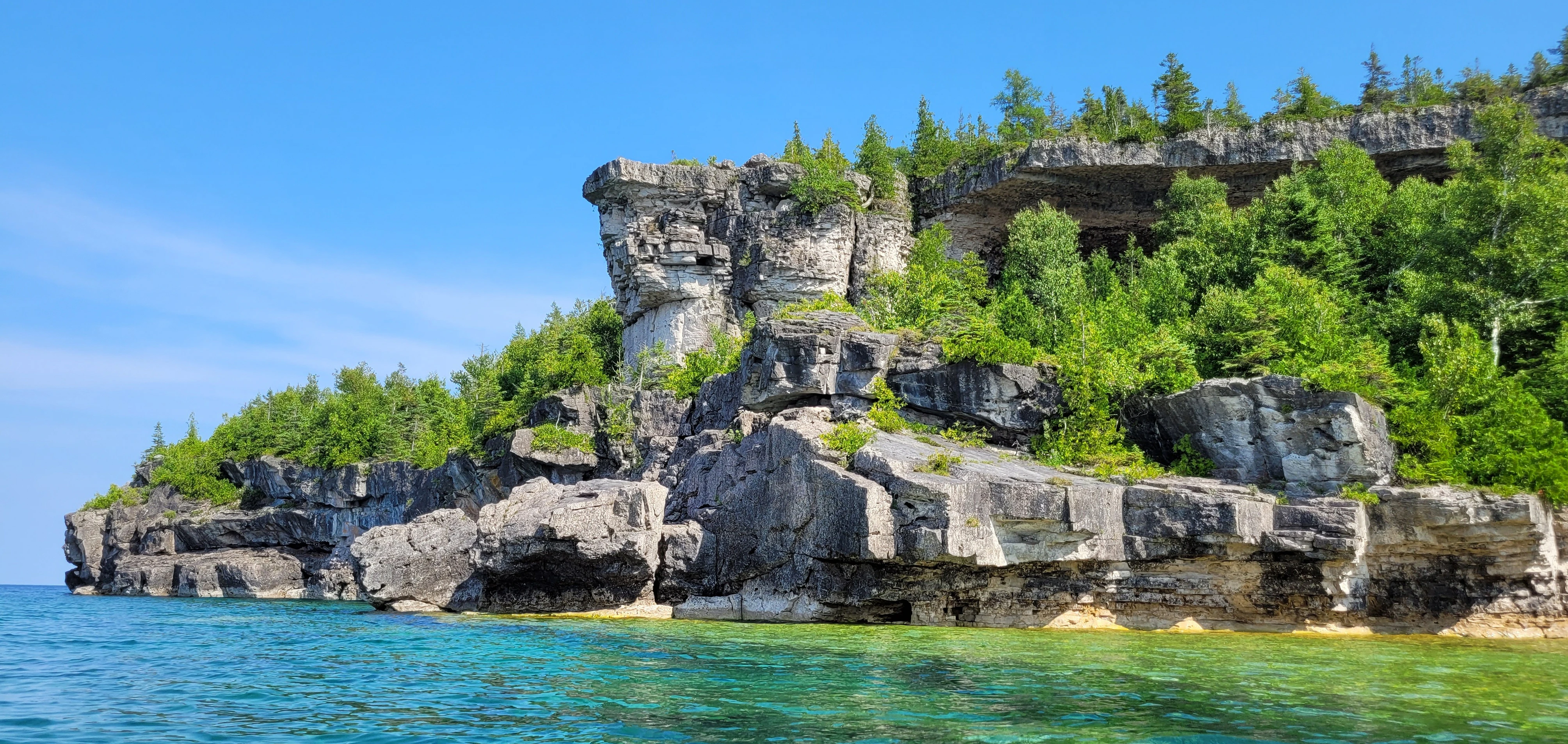 Overhanging limestone point extending over the waters of Georgian Bay