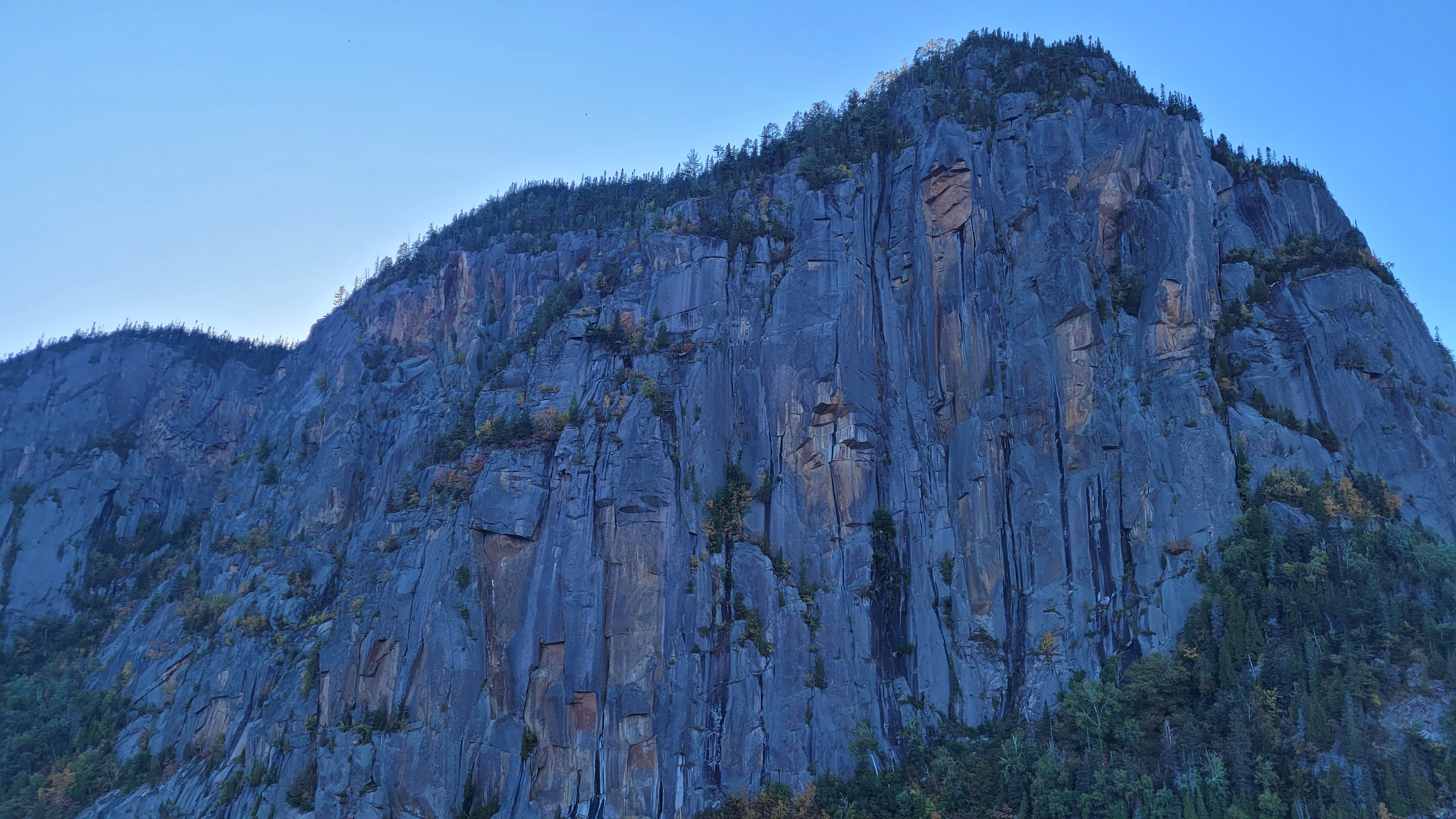 Steep granite cliffs rising above Baie Eternite in the Saguenay Fjord