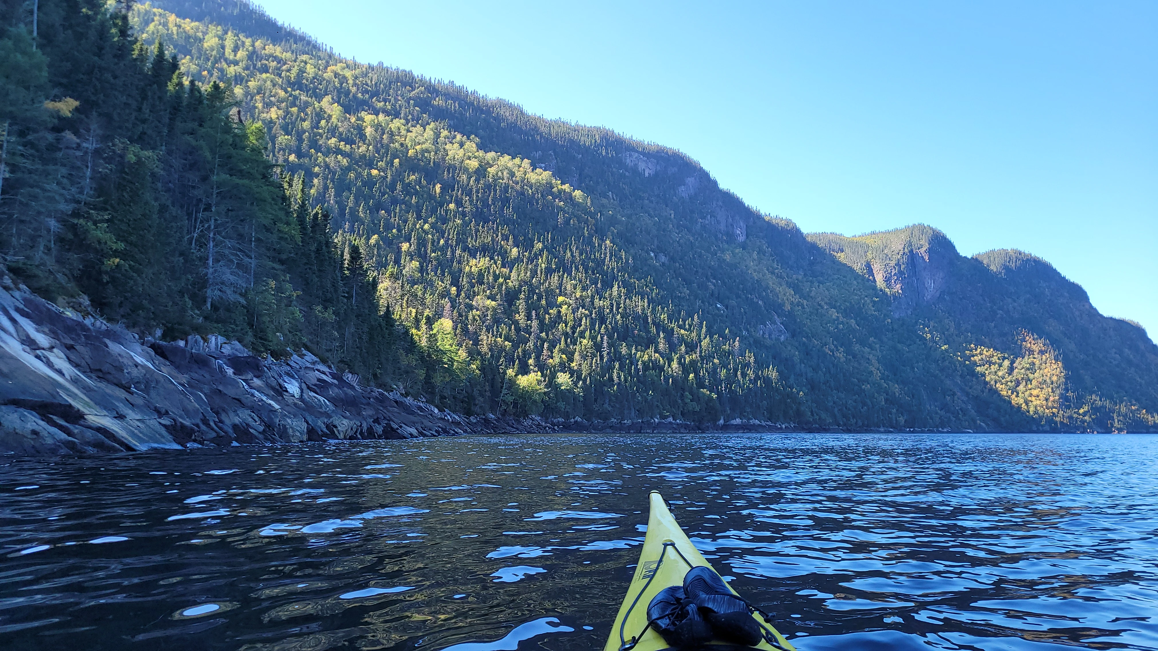 Sea kayaking along the shoreline of the Saguenay Fjord Quebec Canada