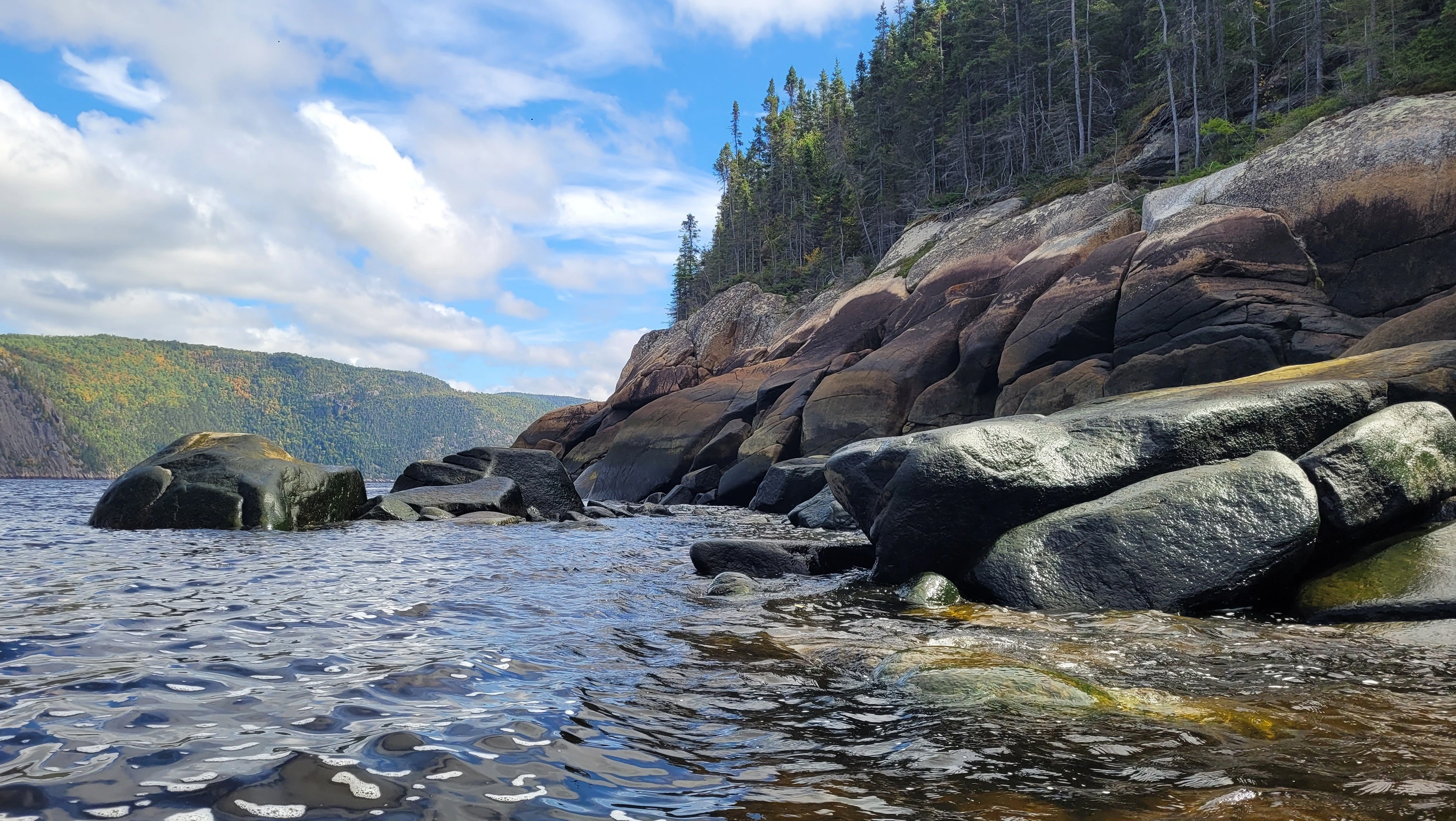 Rocky shoreline along the Saguenay River viewed from a sea kayak