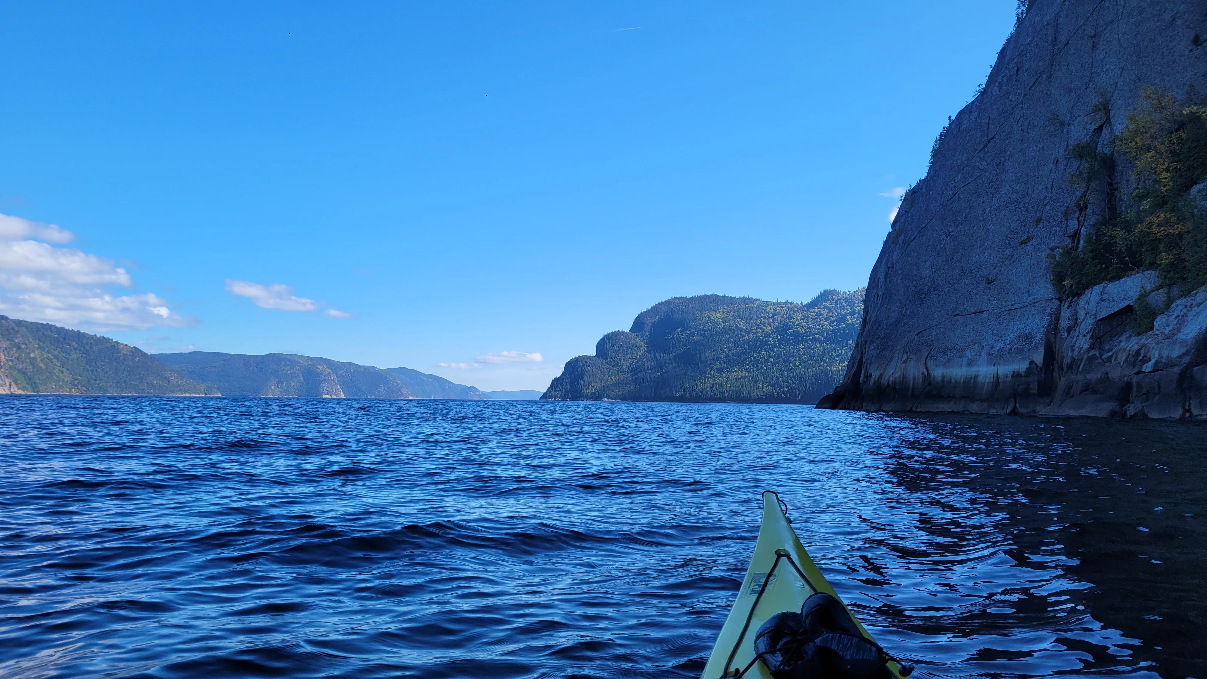 Kayaker's view across the Saguenay River and towering fjord cliffs