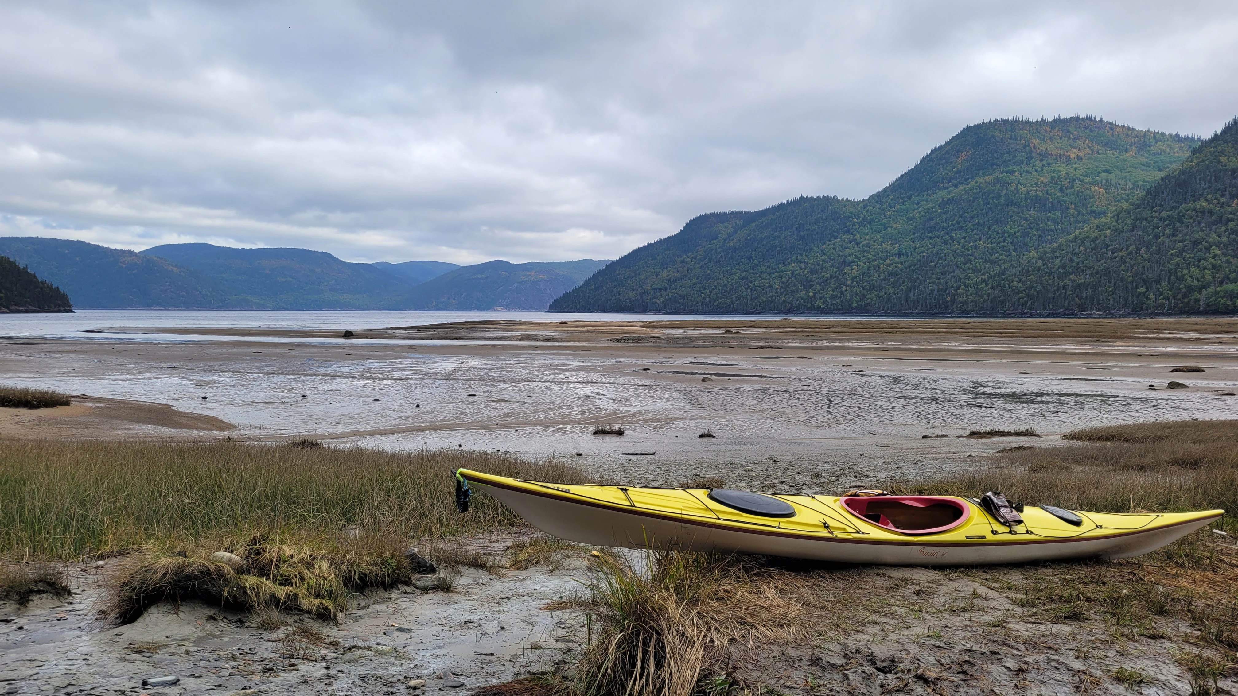 Launching a sea kayak at Baie Eternite in the Saguenay Fjord Quebec Canada