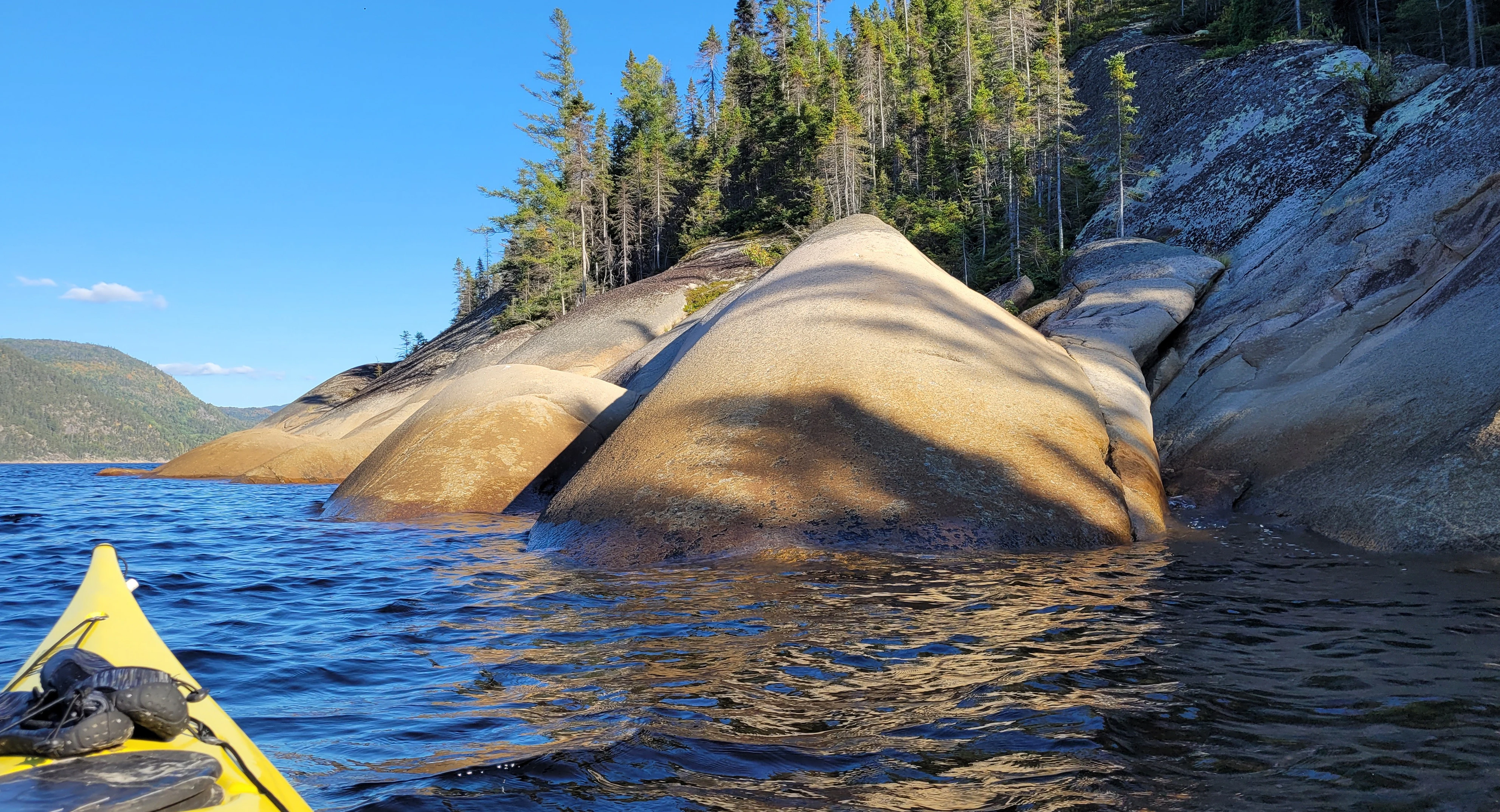 Smooth rock formations along the Saguenay Fjord shoreline