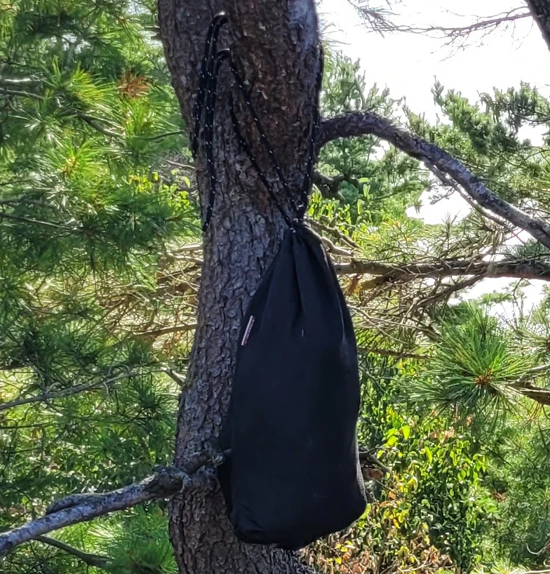 Ursack XL Bear Proof bag hanging from a tree at a campsite