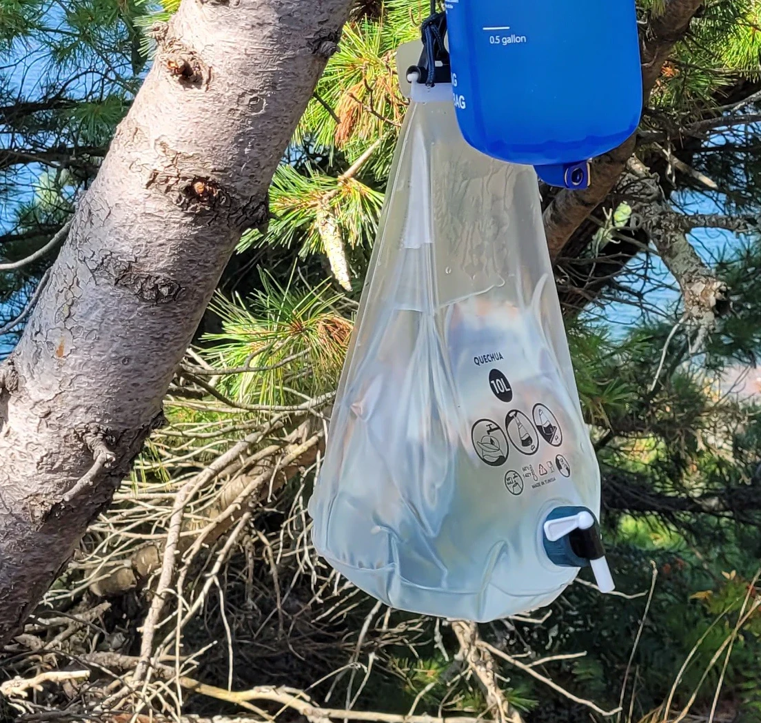 Decatholon Quechua Water 10 liter water bladder hanging from a tree