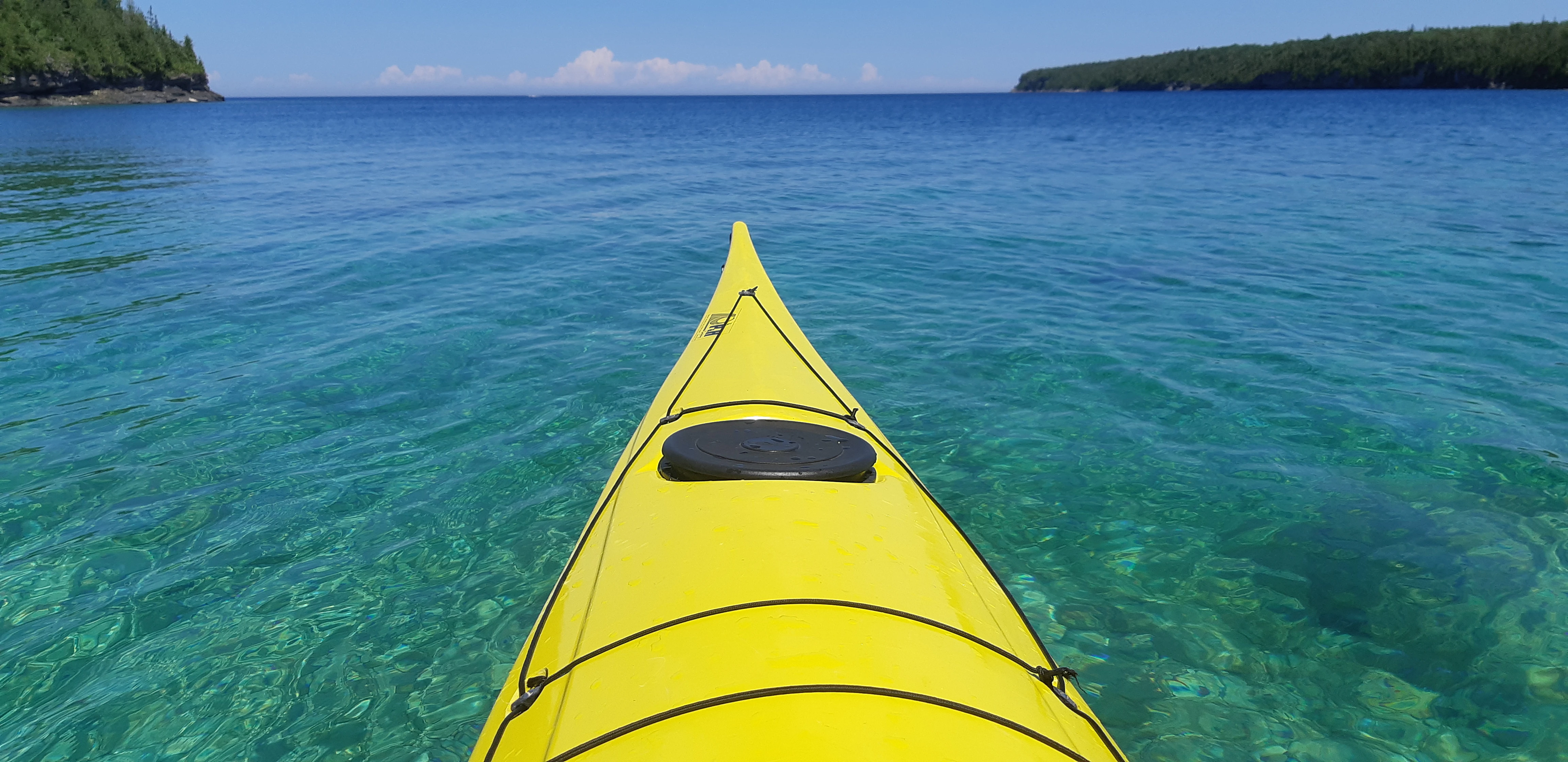 Kayaking on clear, emerald color water in Dunks Bay  Bruce Peninsula National Park, Ontario, Canada