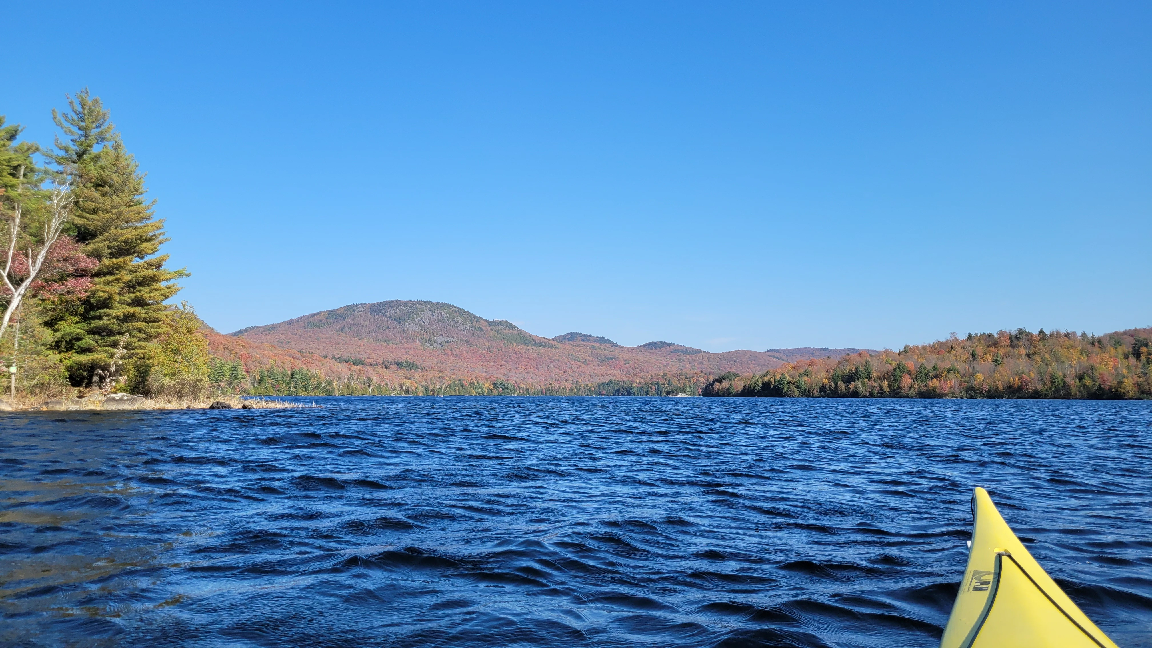Kayaking on a lake during the fall with colorful foliage in Lac Stukley in Orford Quebec